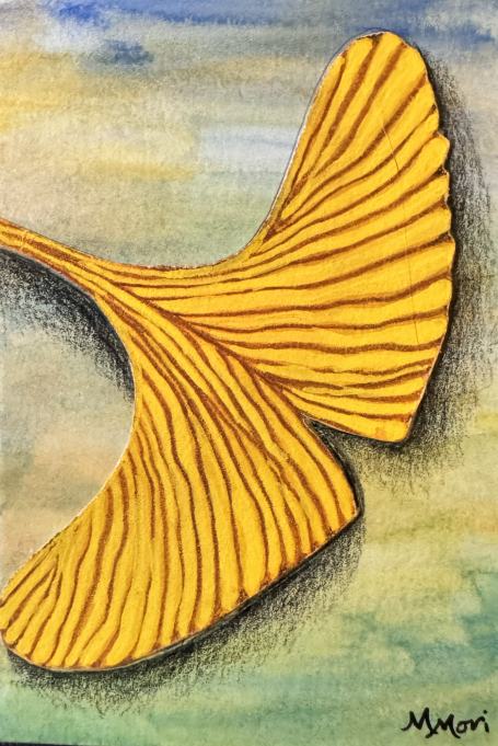 Yellow ginkgo leaf against a watercolor background of muted colors.